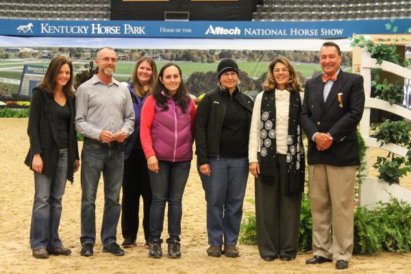 Judge Linda Umla and Alltech National Horse Show President Mason Phelps Jr. present the $2,000 Phelps Media Group Braider's Award to Louise Sinkler, Jeff Claxton and Jennie Vigliano. Photo by Emily Riden.